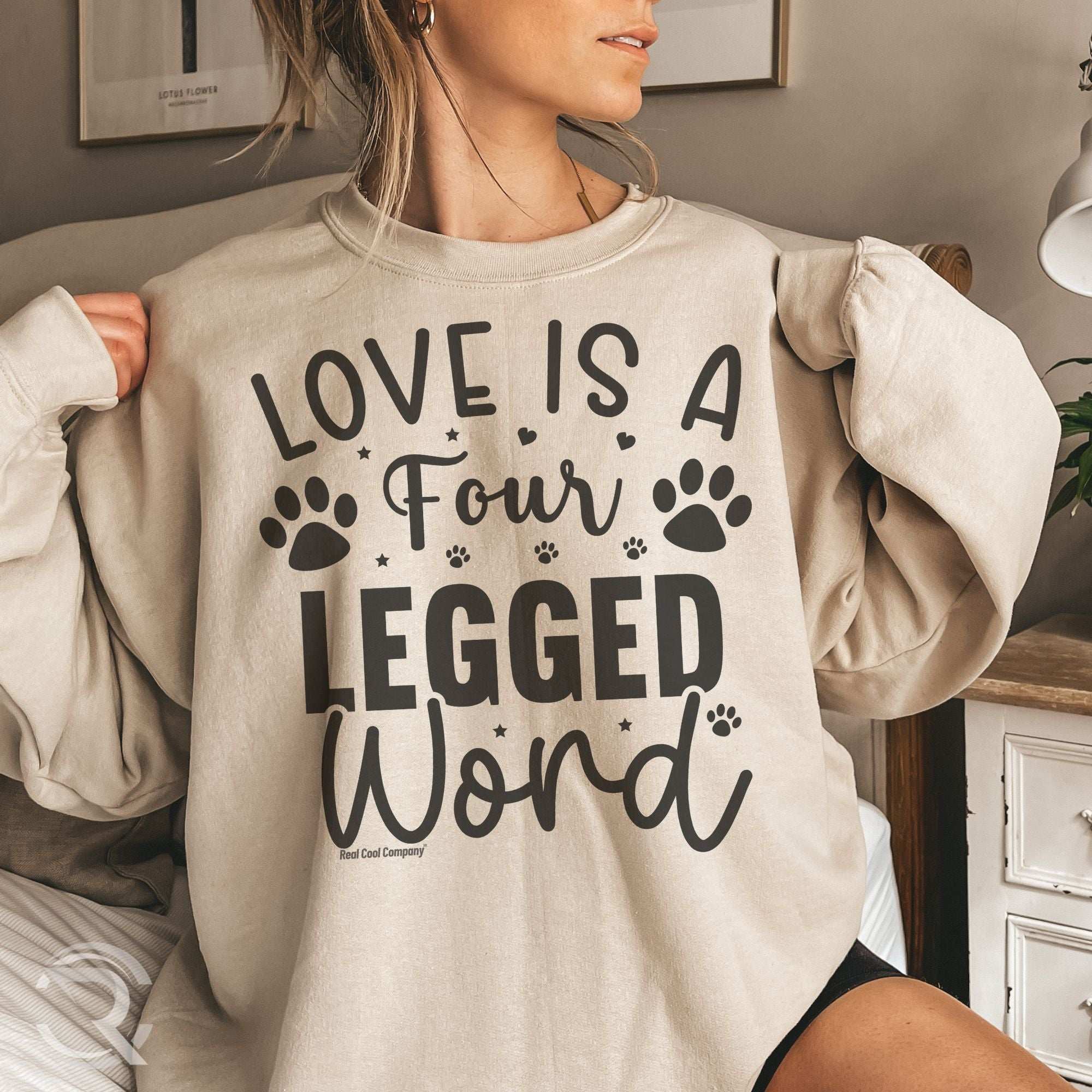 woman sitting on the sofa wearing an oversized sweatshirt with a cute dog quote design