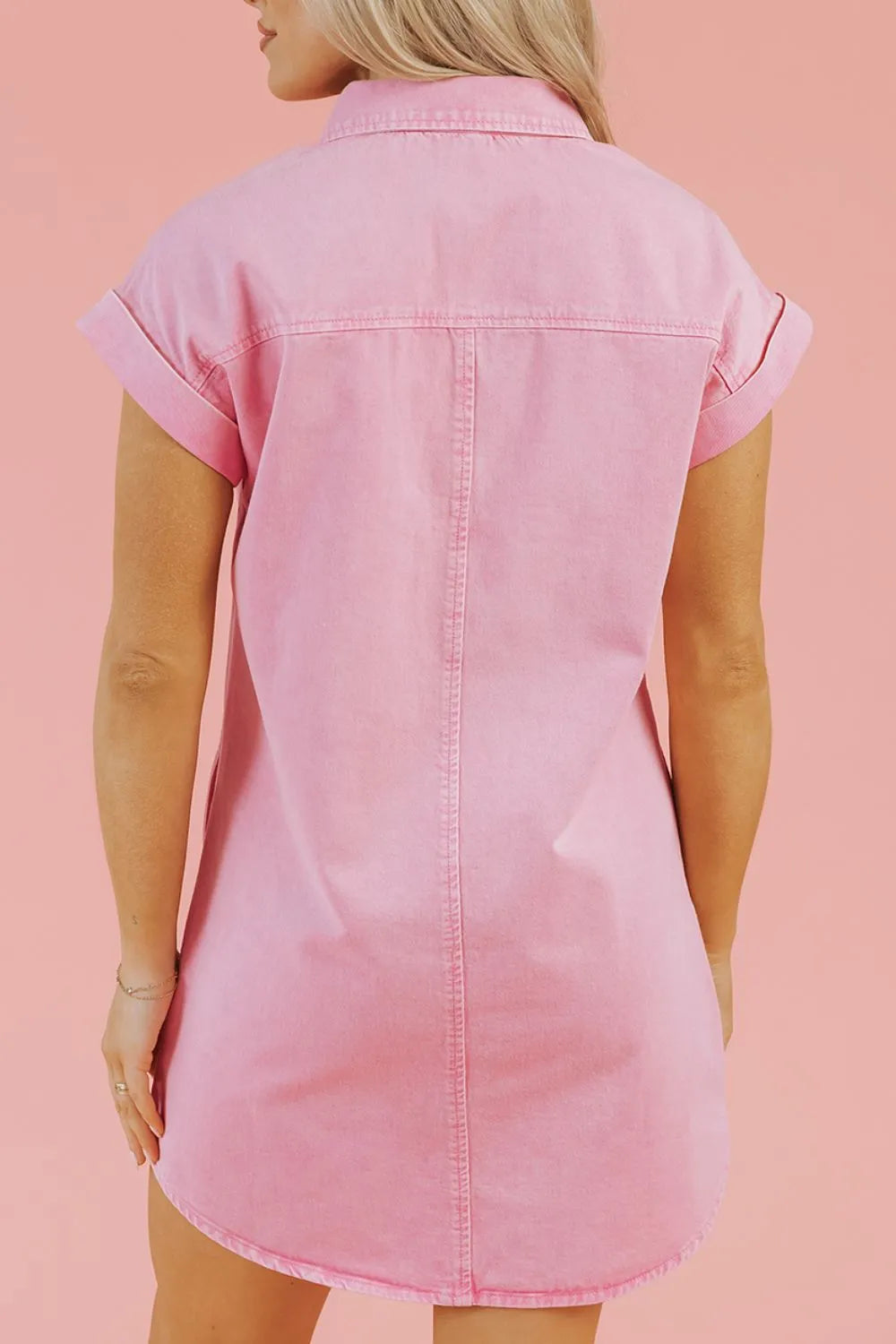 Back View of Woman wearing a Pink Button Down Short Sleeve Denim Dress