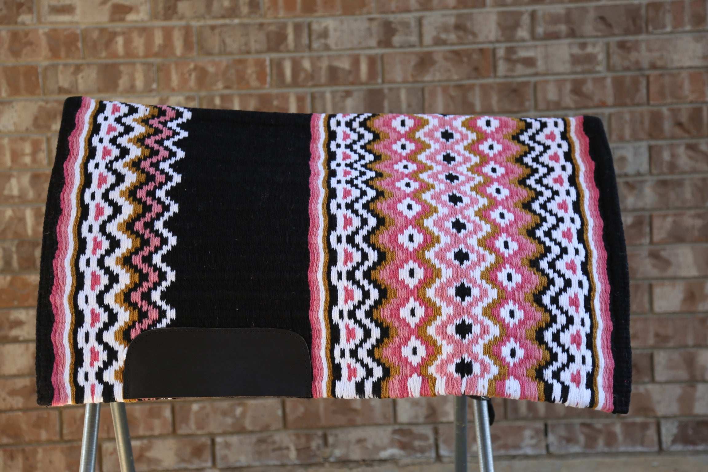 Custom Western Saddle Pad – Earth Tone Hues and Black Details | Limited Edition displayed on a saddle rack