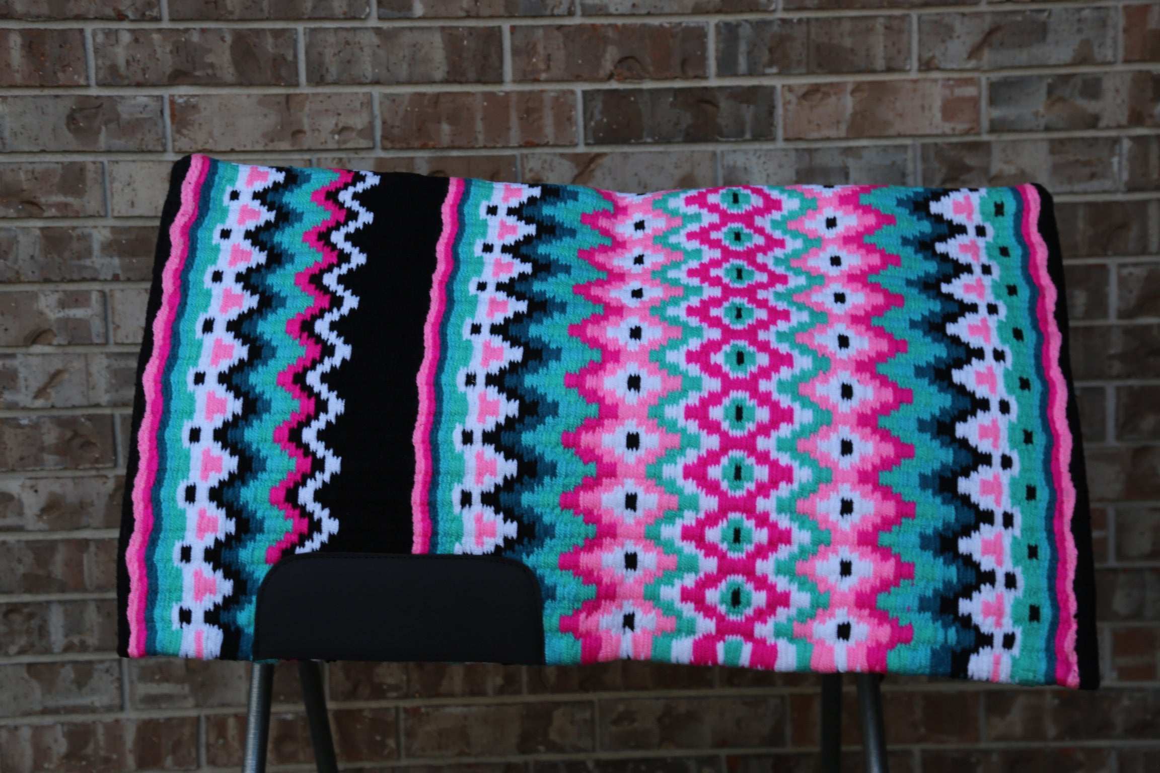 Custom Western Saddle Pad – Pink, Green, Black Details | Limited Edition on Saddle rack