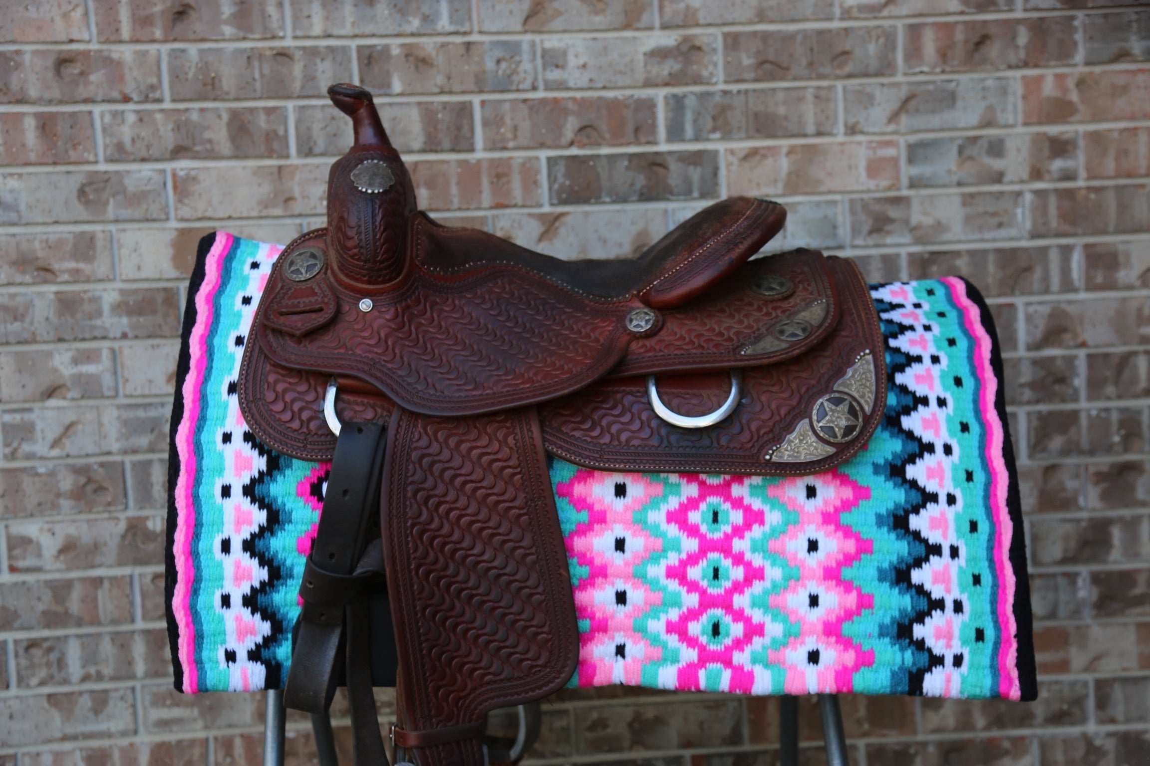 Custom Western Saddle Pad – Pink, Green, Black Details | Limited Edition on Saddle rack with western saddle on top