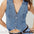 Denim vest worn by a person on a plain background