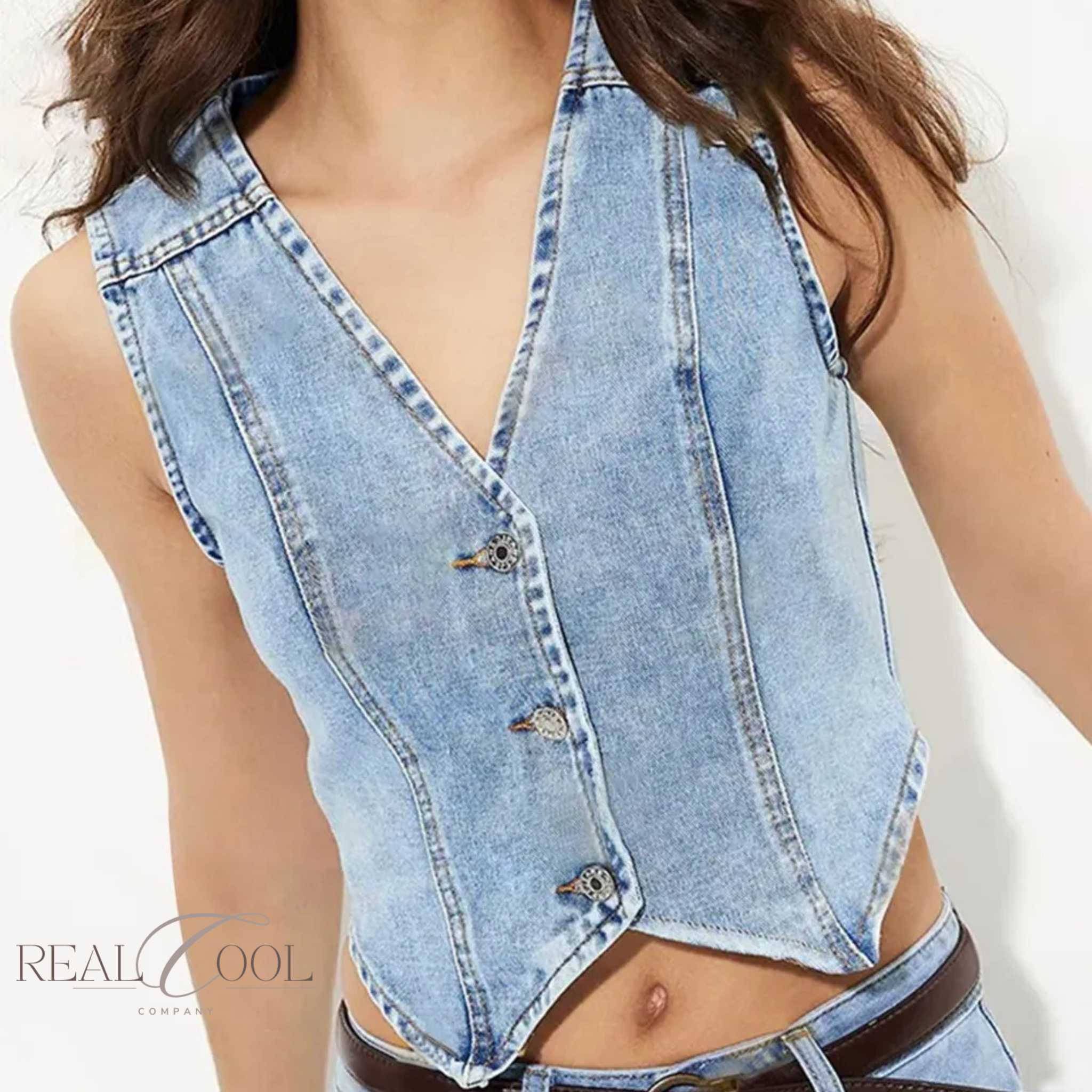 Denim vest worn by a person on a white background with 'Real Cool' branding.