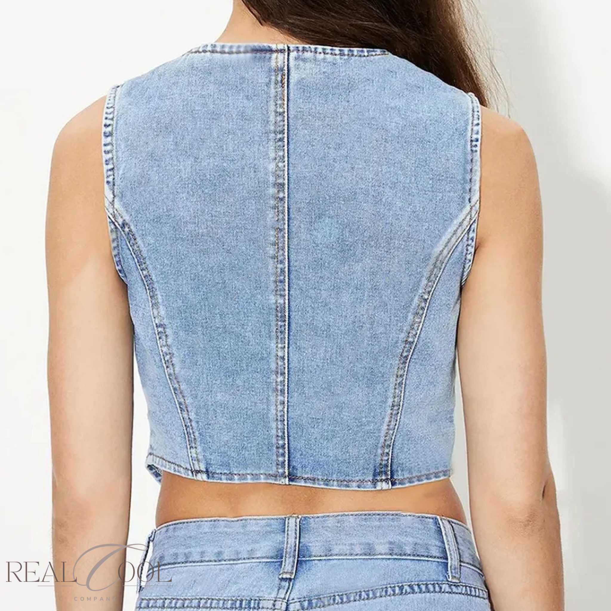 Denim sleeveless top worn by a person on a plain background