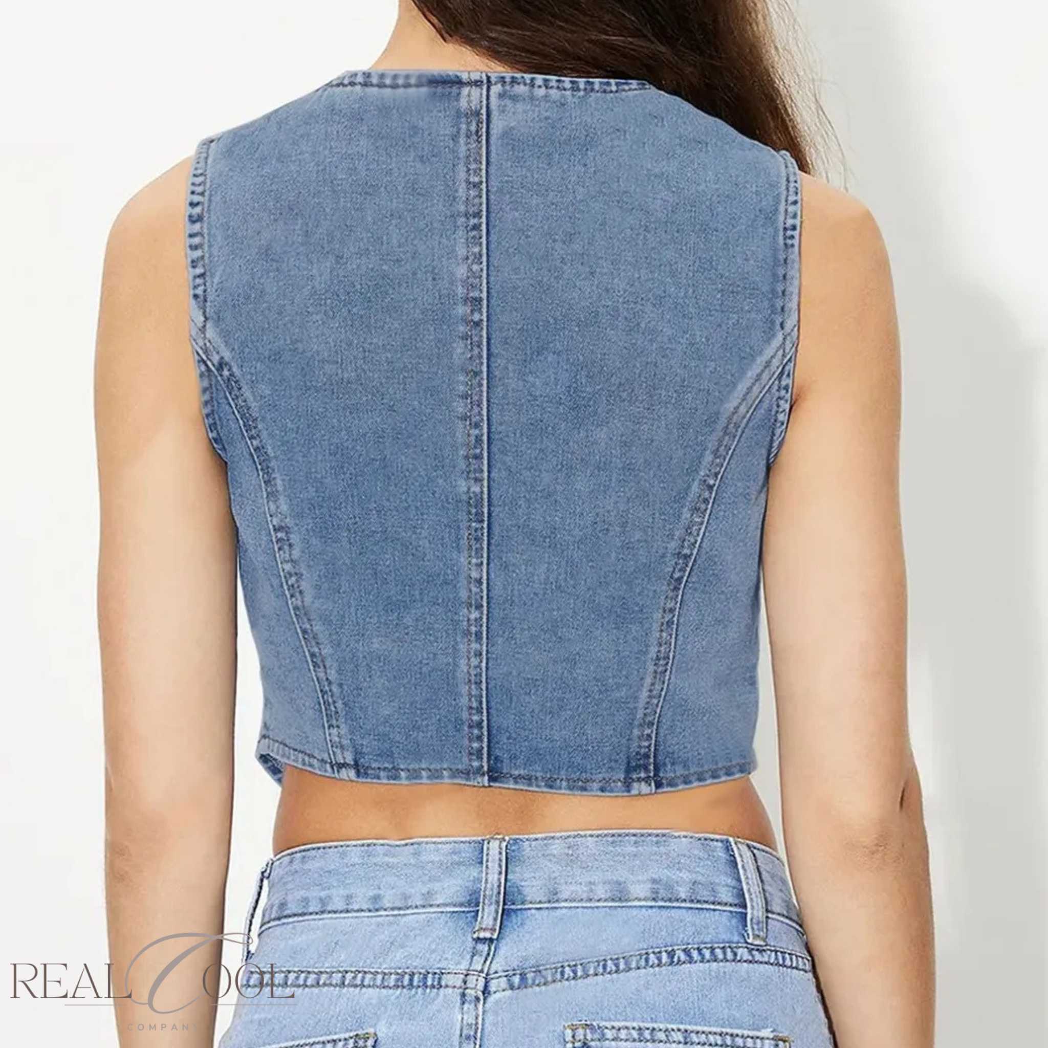 Denim sleeveless top worn by a person on a plain background