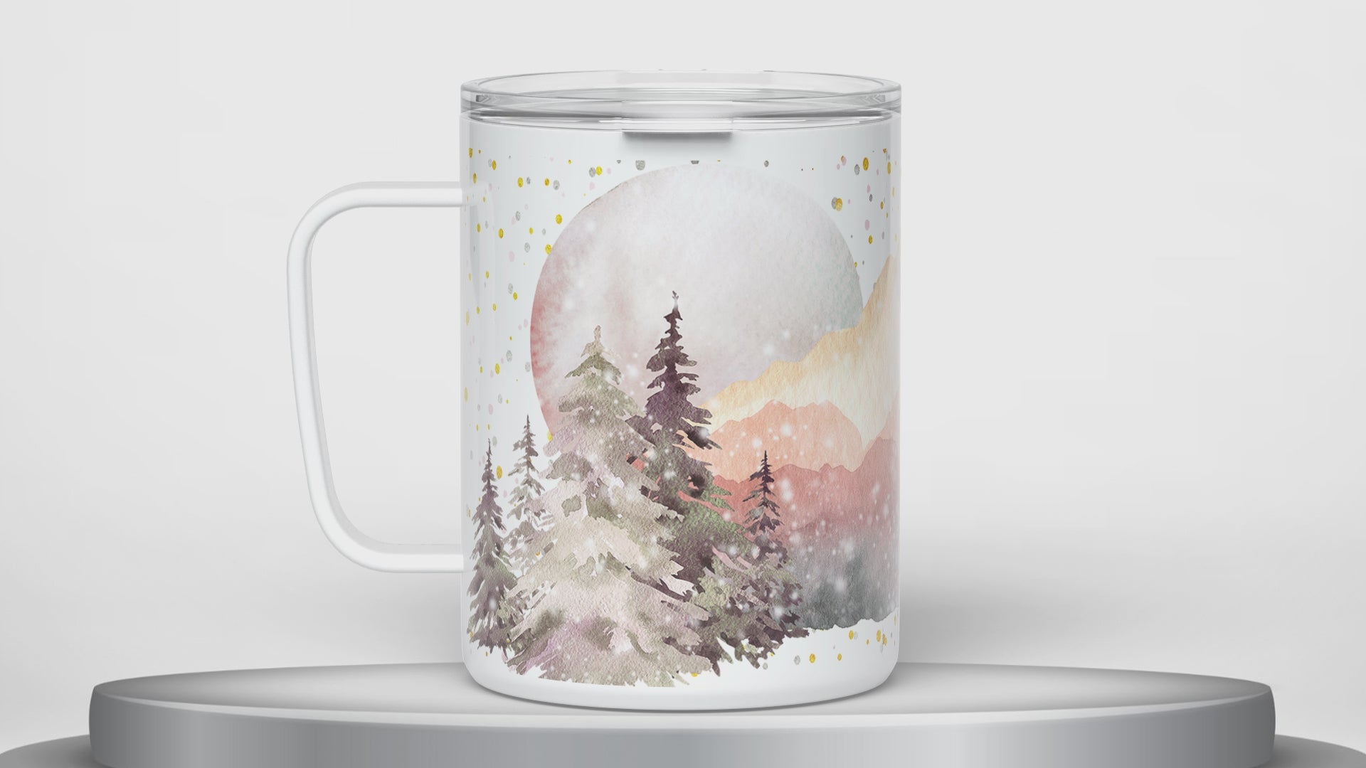 video of white insulated travel mug with lid and handle designed with watercolor mountain nature design rotating 180 degrees on a round platform