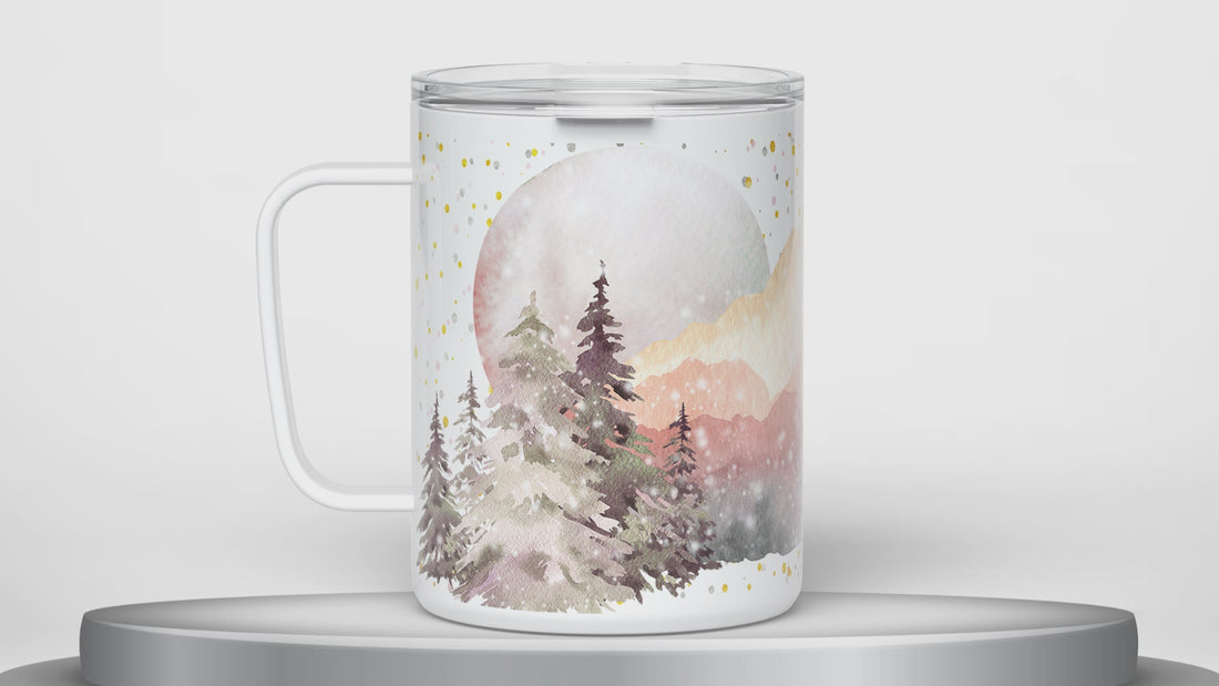 video of white insulated travel mug with lid and handle designed with watercolor mountain nature design rotating 180 degrees on a round platform