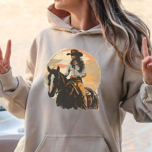 oversized custom hoodie with a custom vintage  watercolor cowgirl riding on her horse and sunset background graphic design