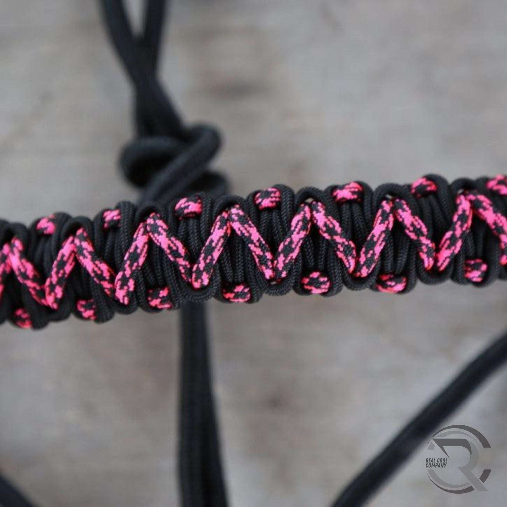 Close-up of a black and pink braided noseband of a horse rope halter